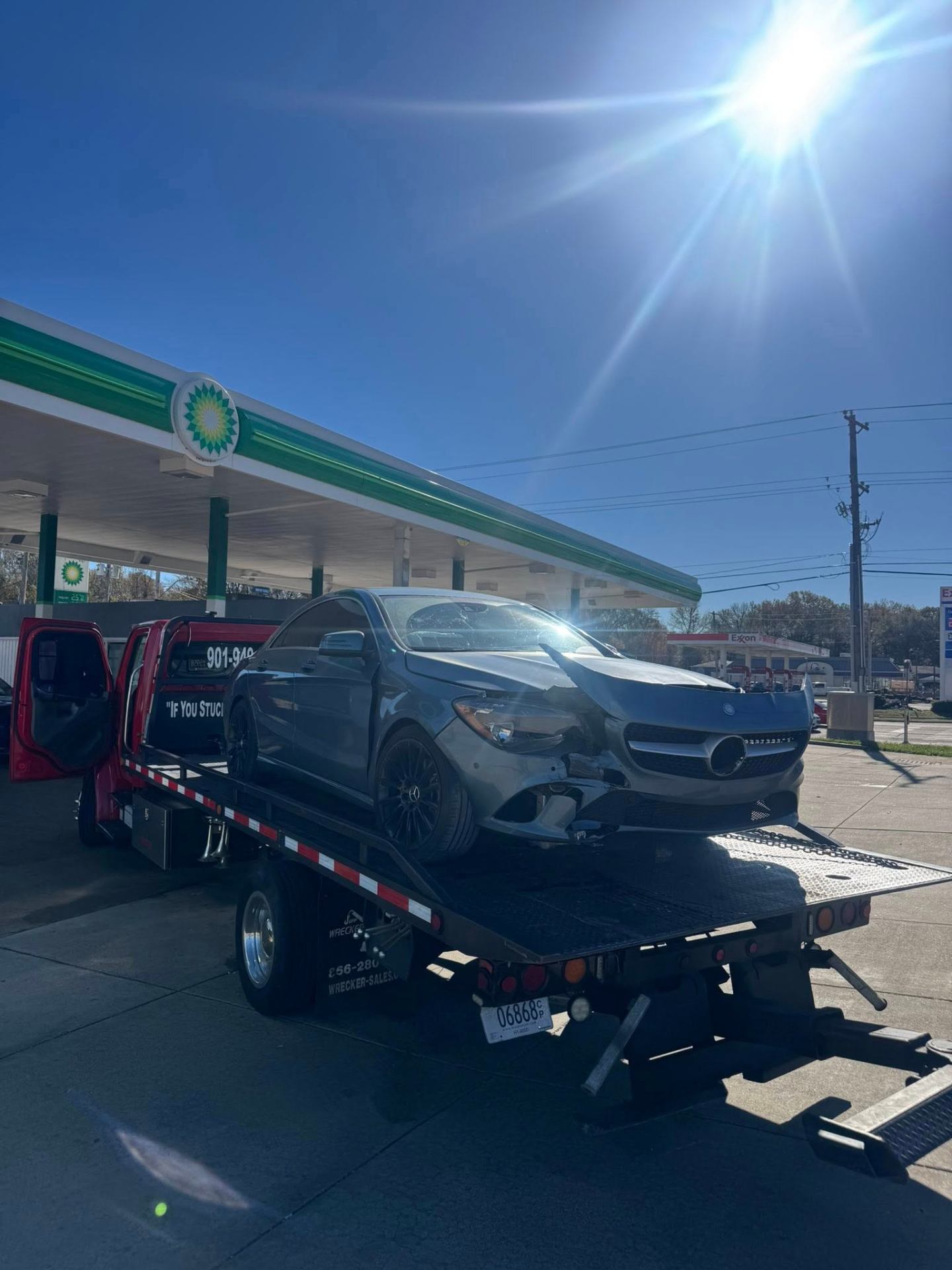 Tow truck loading Mercedes at gas station in Memphis